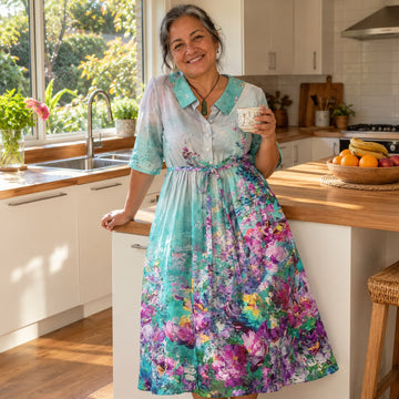 Woman in a watercolour floral dress in her kitchen